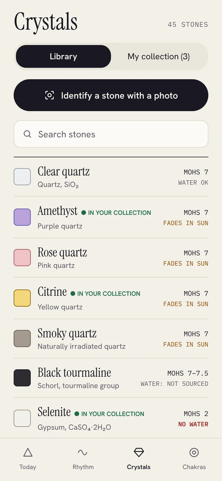 Crystal library of 45 stones with an Identify a stone with a photo button, and water and sun notes for each stone.